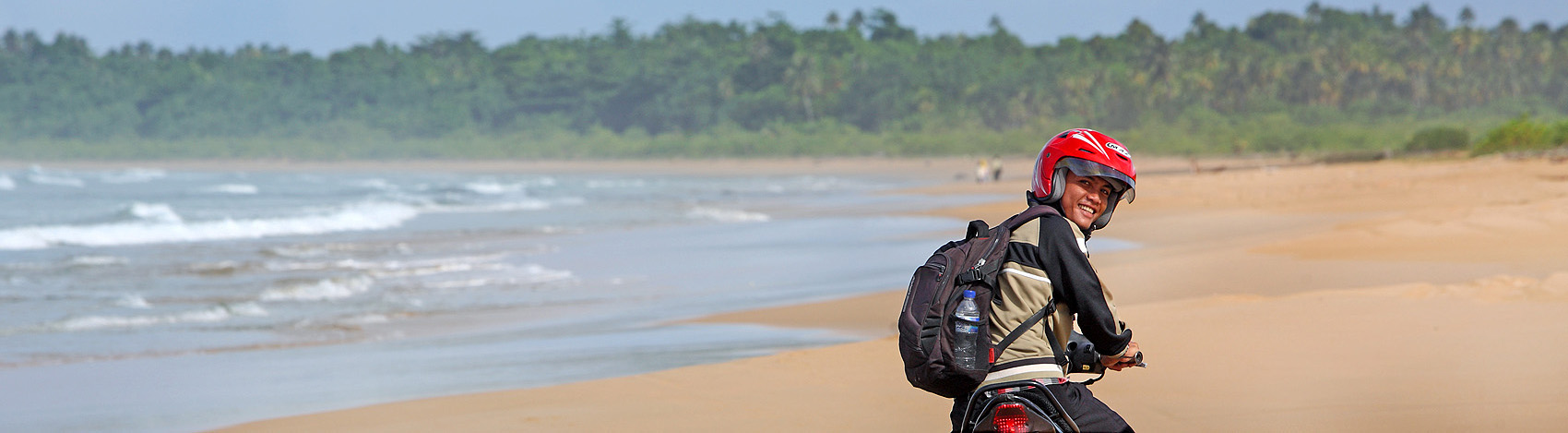 Motorbike touring on Toyalawa beach on the west-coast of North Nias (Nias Utara), Nias Island, Indonesia.