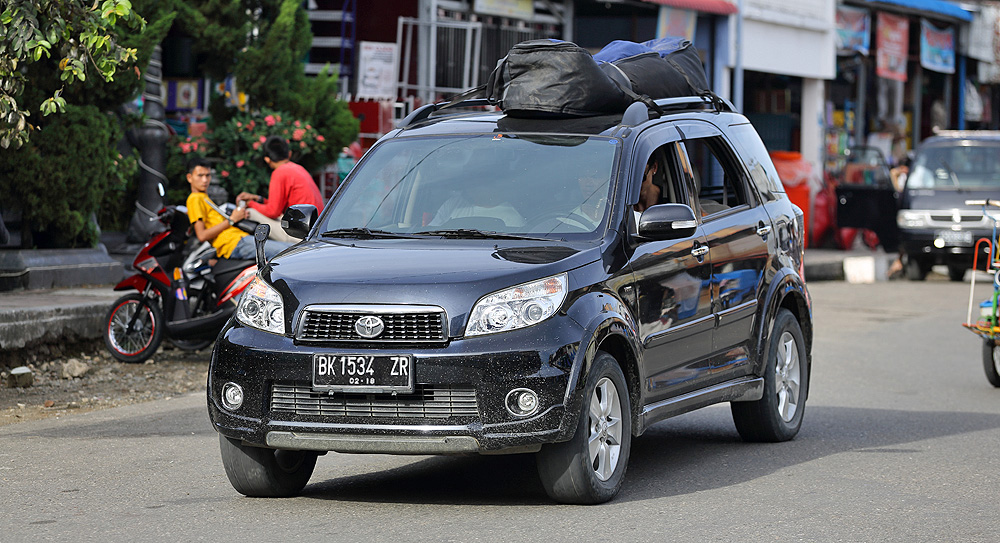 Private taxi taking surfers from the airport to various surf locations on Nias Island, Indonesia.